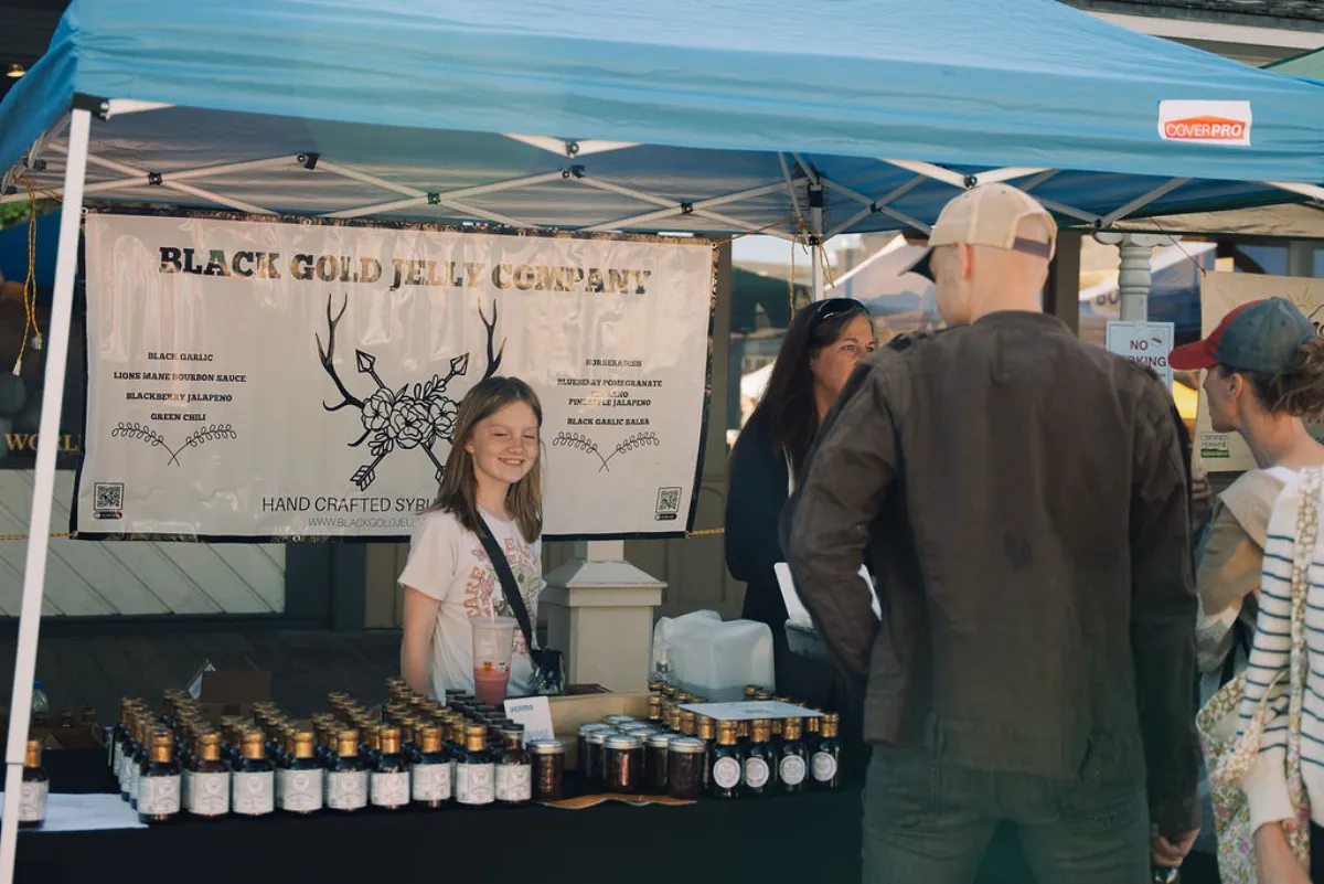 Black Gold Jelly Company booth with jars of handcrafted syrups