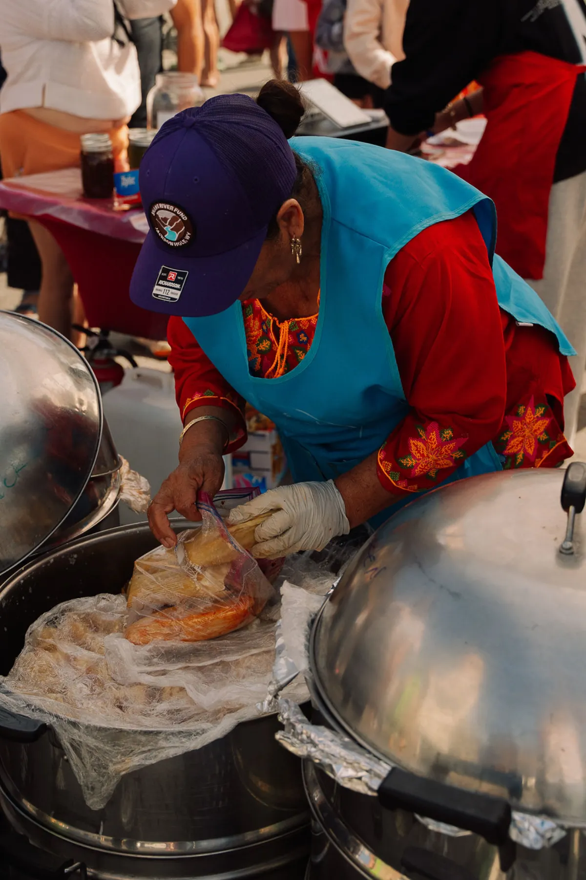 Vendor preparing fresh tamales at the market