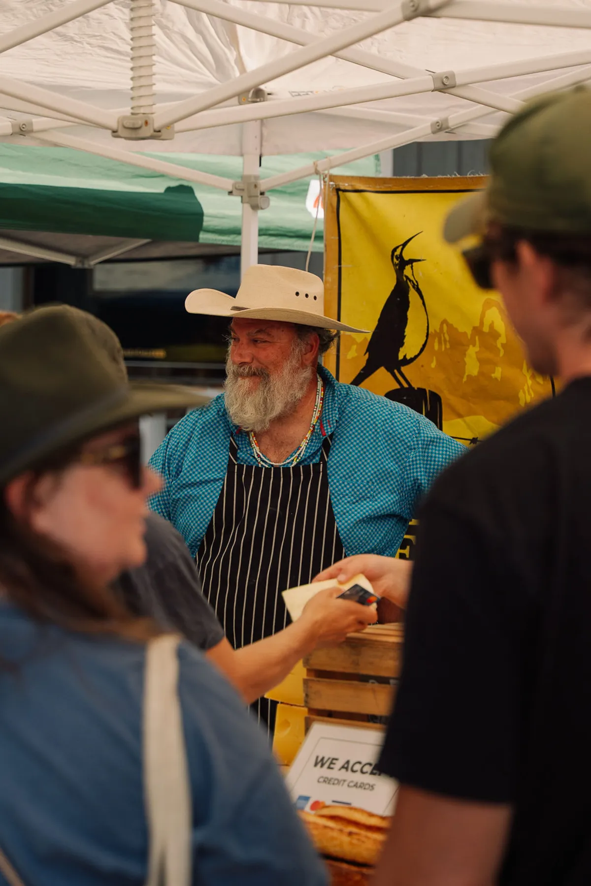 Local rancher vendor serving customers at his booth