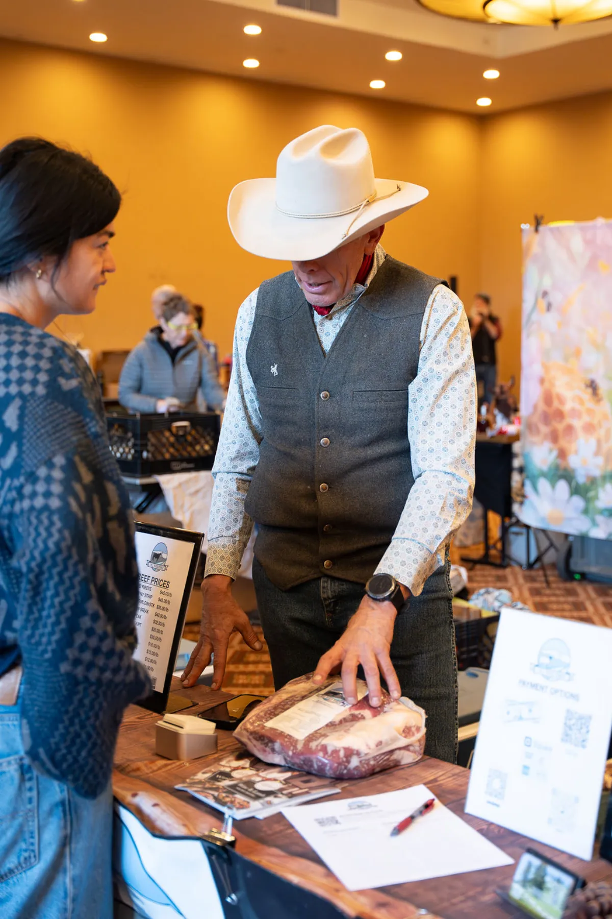 Local rancher showing a cut of beef at the winter market