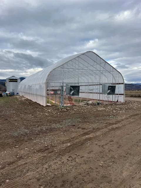The greenhouse structure at Haderlie Farms with ventilation fans visible at one end