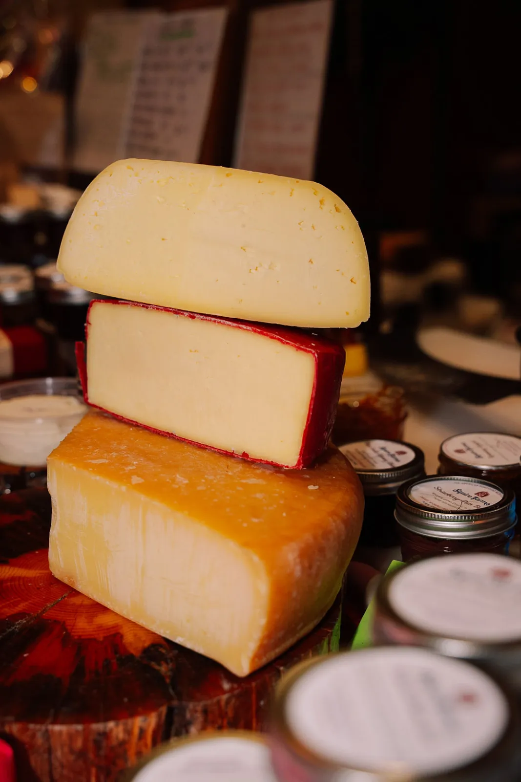 A stack of artisan cheese wheels at the winter market