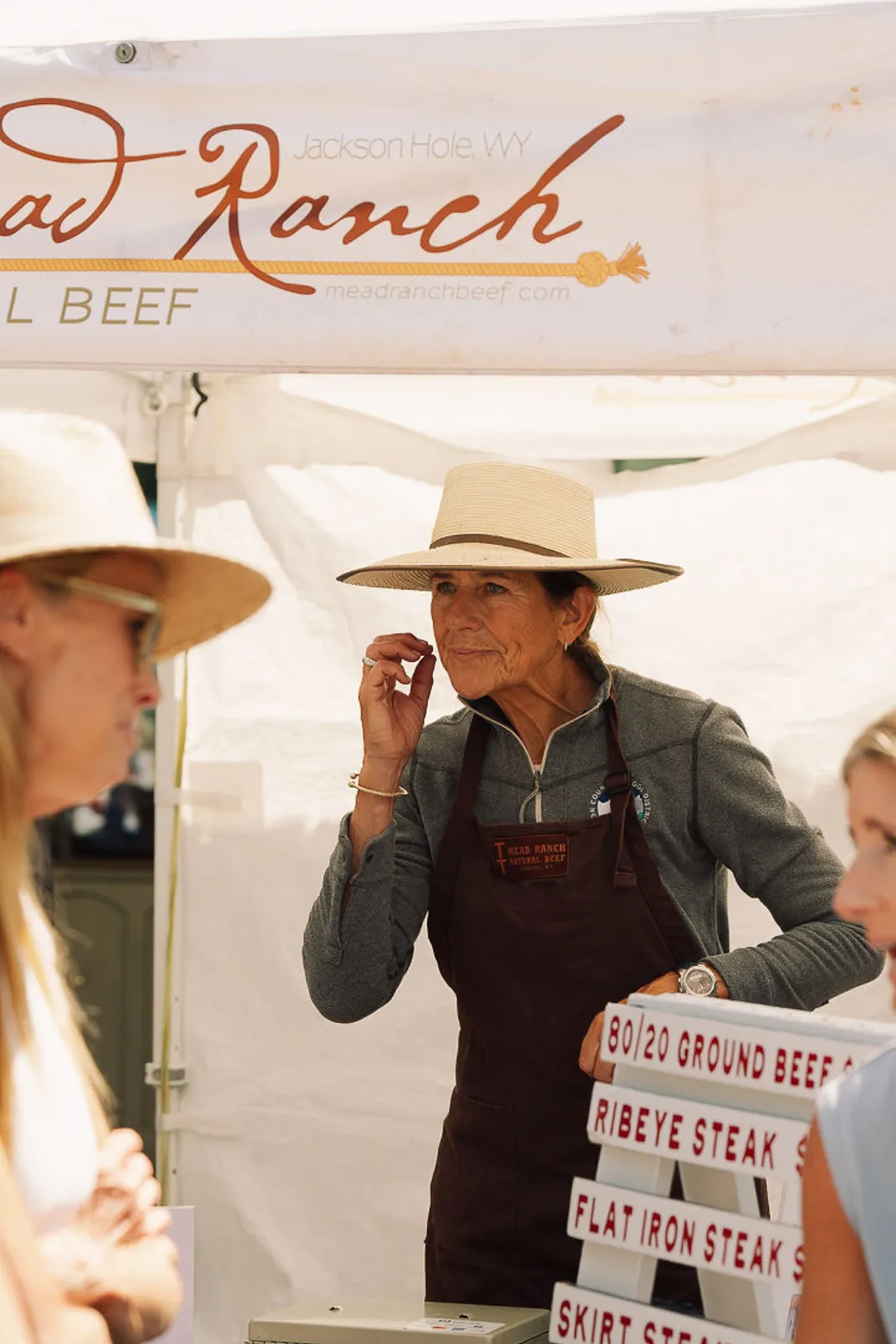 A Mead Ranch vendor talking with customers at the beef stand