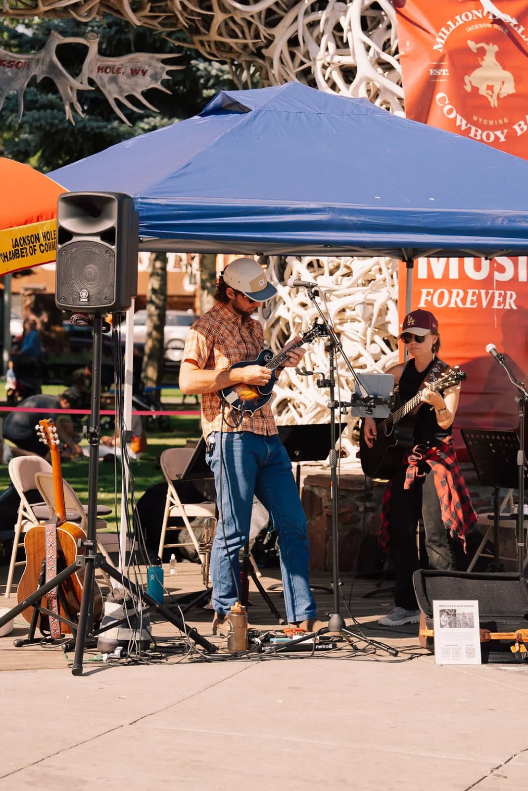 A live band playing under a tent at the Saturday market