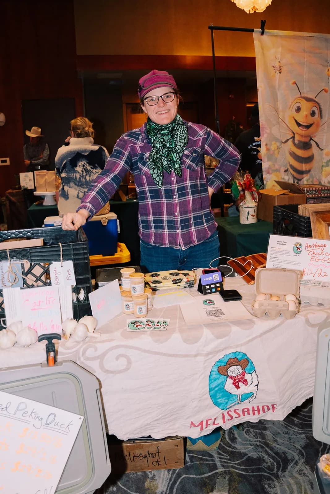 A vendor at their booth at the winter market